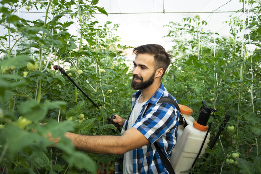 The current image has no alternative text. The file name is: young-bearded-farmer-worker-spraying-plants-with-pesticides-protect-against-disease-scaled.jpg